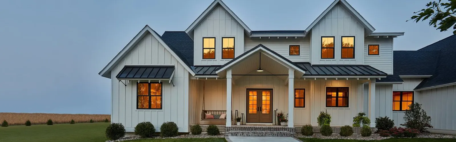 Modern farmhouse-style home exterior at dusk
